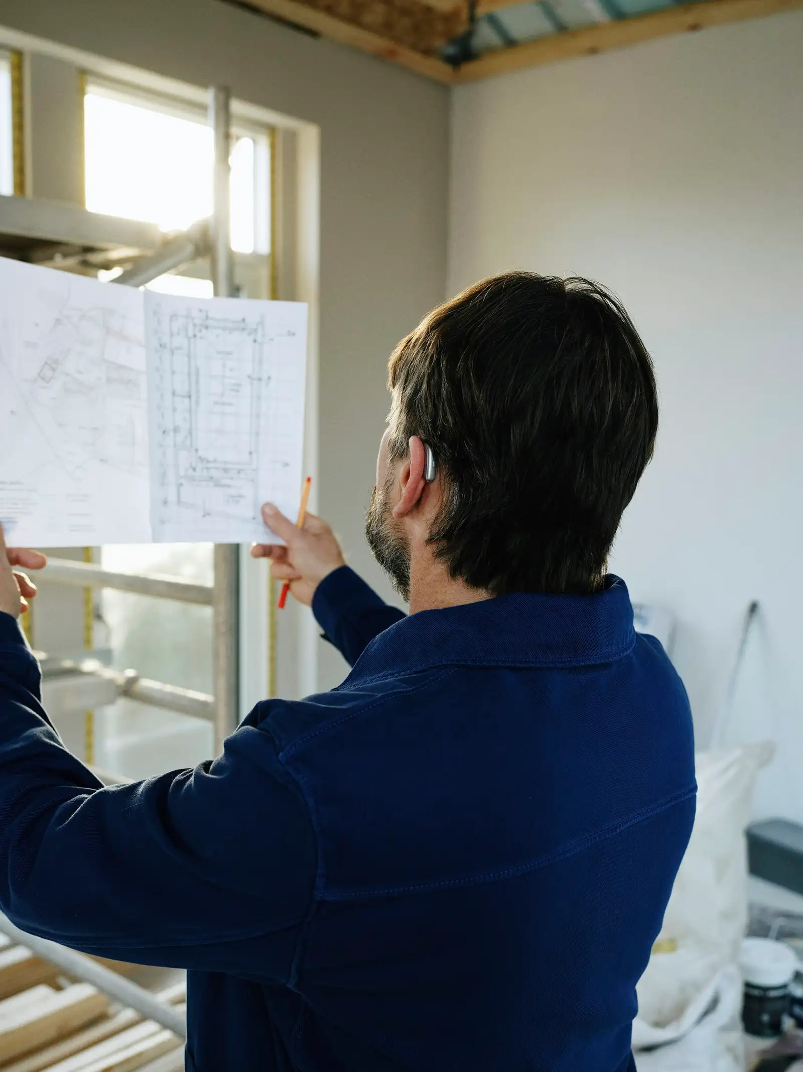 An architect checking a drawing on site