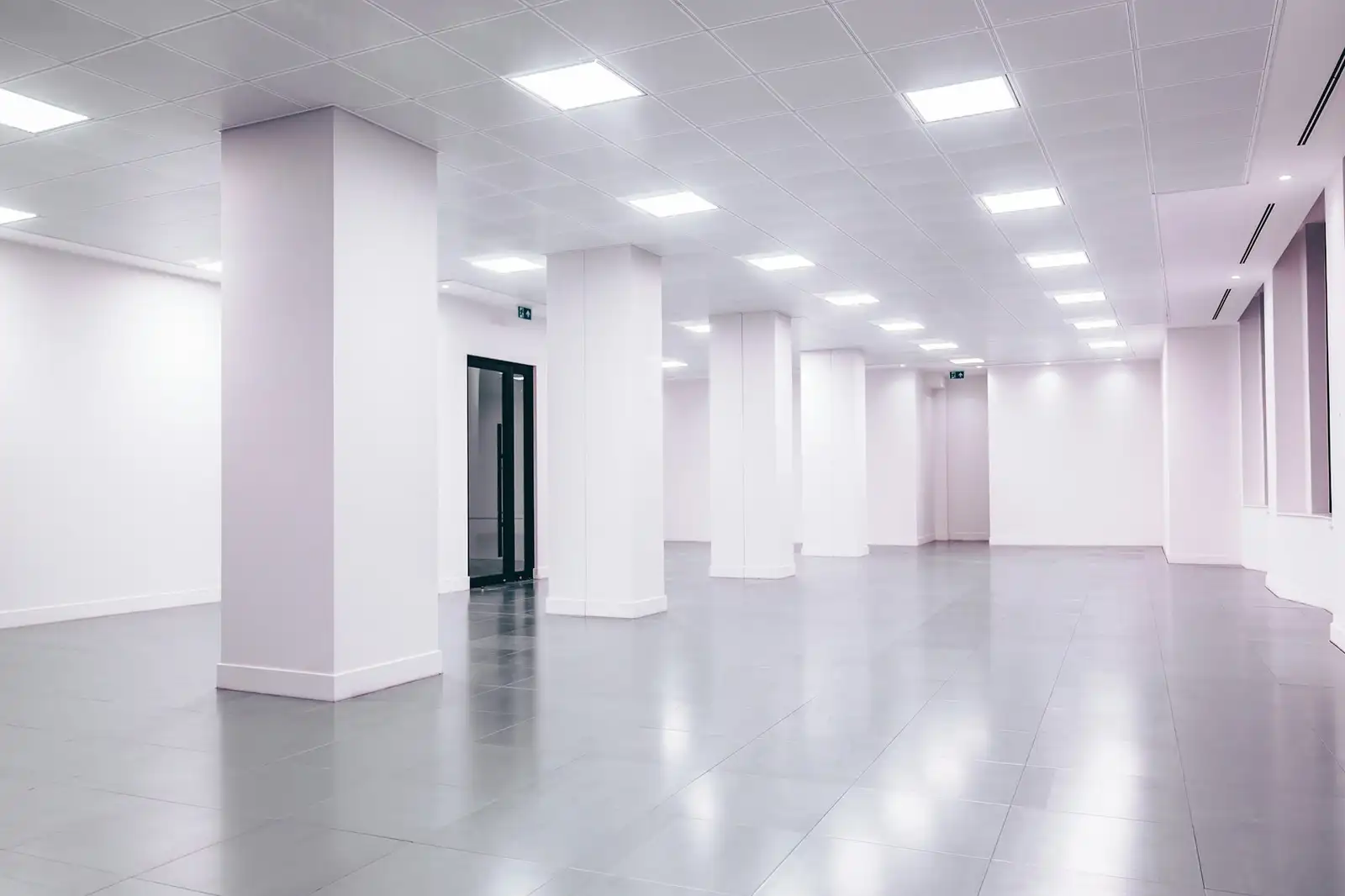 A bright, empty commercial space with columns