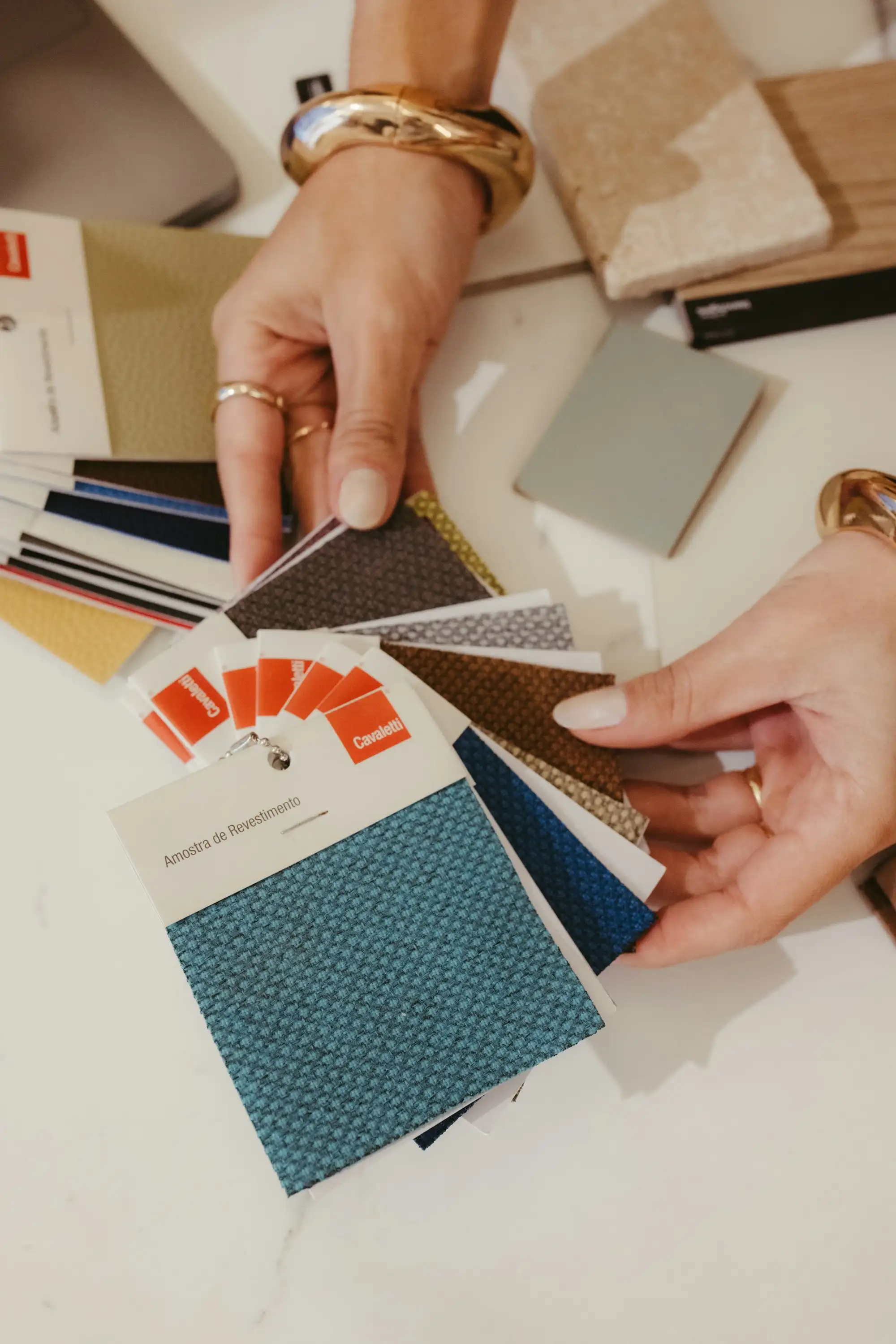 Hands choosing fabric and finish samples
